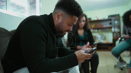 Photo for People addicted to their phones, people in social alienation not interacting with each other. Technology addiction, friends staring at screens - Royalty Free Image