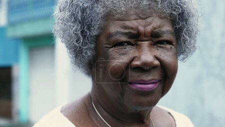 Photo for One pensive senior black lady with wrinkled face and gray hair. Portrait of an old African American woman in her 80s showing wisdom and old age with thoughtful gaze - Royalty Free Image