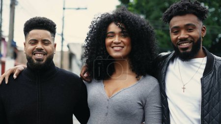 Photo for Group of Brazilian friends smiling at camera standing in city street. Latin South American people of African American descent portrait faces - Royalty Free Image