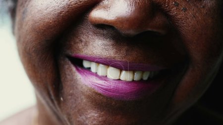 Photo for Macro close-up of a happy Senior black woman smiling at camera with wrinkled face showing wisdom and old age. Portrait of an African American lady in her 80s - Royalty Free Image