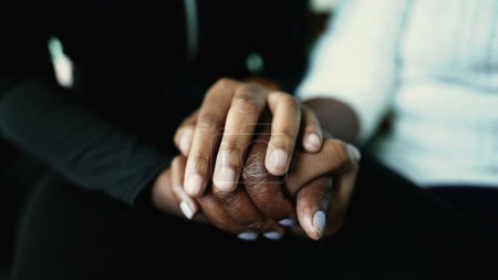 Photo for Macro closeup detail of hands held together in support and help during senior age. Grand-daughter hand holding elderly grandmother's wrinkled hand showing love - Royalty Free Image