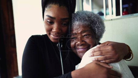 Photo for African American granddaughter hugging elderly 80s grandmother showing support and help for inter-generational family member. Family unity and love during old age - Royalty Free Image