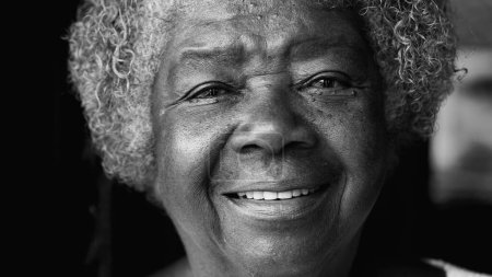 One happy black elderly senior woman with wrinkles and gray hair smiling at camera. Portrait of a friendly South American 80s person of African descent