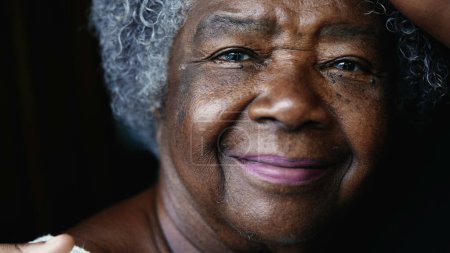Photo for Joyful South American elderly black lady in 80s depicting wisdom wrinkles in old age. Gray-hair Senior woman of African descent looking at camera smiling - Royalty Free Image