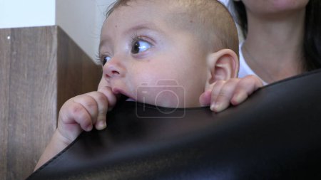 Photo for Cute Baby toddler putting plastic object in mouth biting - Royalty Free Image