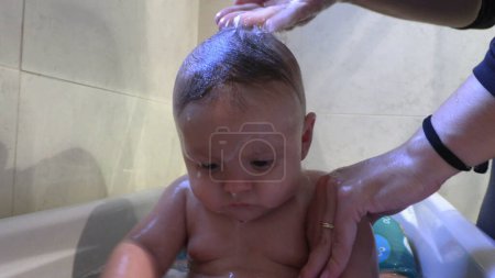 Photo for Baby inside bathtub bathing toddler infant - Royalty Free Image