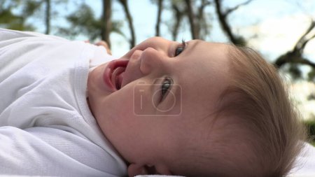 Photo for Beautiful happy baby toddler child authentic smiling laughing outdoors - Royalty Free Image