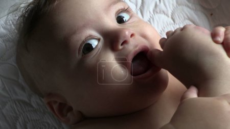 Photo for Cute baby putting feet and toes in mouth - Royalty Free Image