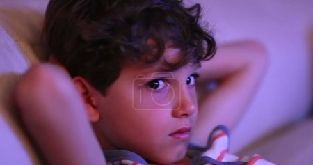 Photo for Candid young boy watching TV screen - Royalty Free Image