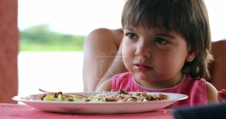Photo for Portrait of little cute girl at supper table - Royalty Free Image