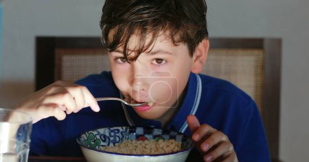 Photo for Small boy eating cereal for breakfast morning - Royalty Free Image