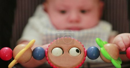 Foto de Newborn baby playing chair toy - Imagen libre de derechos