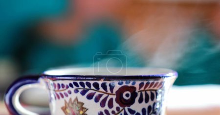 Foto de Warm cup of coffee or tea with child in the background, morning breakfast close-up scene - Imagen libre de derechos