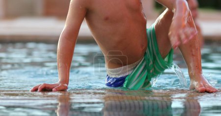 Photo for Candid toddler child boy exiting swimming pool - Royalty Free Image