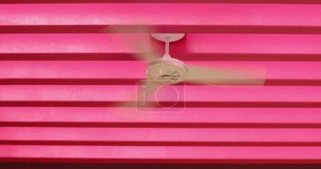 Téléchargez les photos : Fan ventilator on ceiling in pink colorful background architecture patterns - en image libre de droit