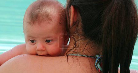 Foto de Mom holding baby boy at the pool - Imagen libre de derechos