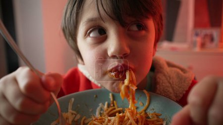 Photo for Little Boy Enjoying Pasta, Close-Up of 5-Year-Old Child Twirling Spaghetti with Fork, Independent Kid Dining Experience - Royalty Free Image
