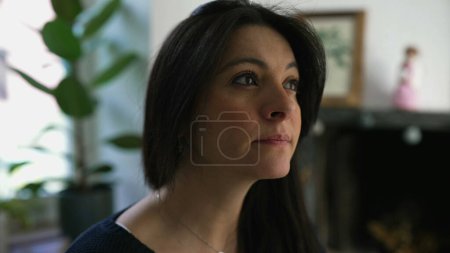 Photo for Pensive 30s woman close-up face in deep mental reflection pondering solution, indoors at home - Royalty Free Image
