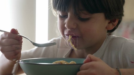 Cheese Spaghetti Delight - Hungry 5-Year-Old Enjoying Pasta, Close-Up of Boy Eating