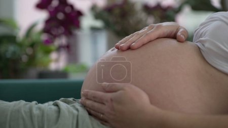 Foto de Mujer embarazada acariciando el vientre de cerca en previsión de una nueva vida - Imagen libre de derechos