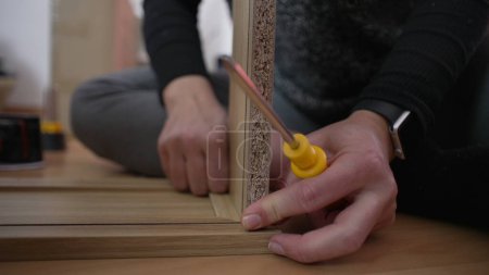 Hand in Hand Möbel zusammensetzen, DIY-Setup. Person, die zwei Holzstücke zusammensetzt. Umzug in neues Heimkonzept