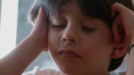 Photo for Pensive little boy with slight annoyed expression contemplating solution to problem, close-up face of one male caucasian 5 year old kid in deep mental reflection - Royalty Free Image