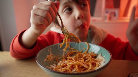 Photo for Young Child Delighting in Spaghetti Dinner, 5-Year-Old Boy's Meal Enjoyment, Close-Up of Happy Pasta Eating Experience 480p.m - Royalty Free Image