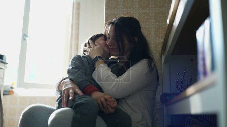 Photo for Tender Moment in the Kitchen/ Son Kissing his mother on the Cheek, Reflecting the Loving Relationship and Strong Bond Between Parent and Child in an Authentic Family Scene - Royalty Free Image