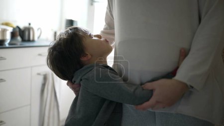 Photo for Tender affectionate moment between mother and child in genuine authentic family moment. Daily life glimpse of mom caressing son's hair - Royalty Free Image