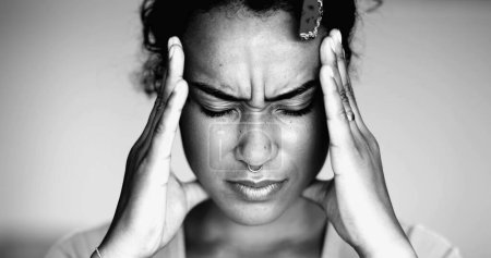 Photo for Overwhelmed young African American woman pressing head side temples feeling mental pressure and anxiety, close-up face of person feel stress and indignation - Royalty Free Image