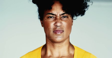 Photo for One angry young black woman screaming at camera feeling distraught gesturing with hands yelling. Upset 20s person of African descent - Royalty Free Image