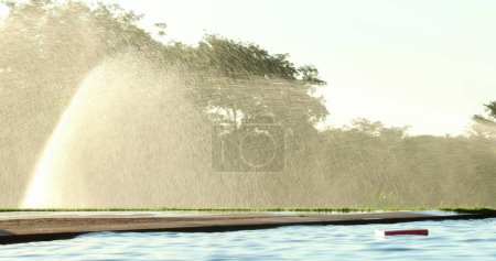 Foto de Water sprinkles watering lawn garden irrigation - Imagen libre de derechos