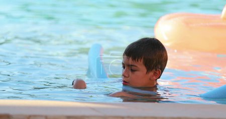 Photo for Little boy playing with Swimming Aid Float Noodle - Royalty Free Image