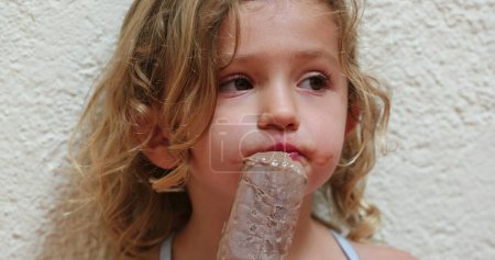 Téléchargez les photos : Cute adorable little girl eating chocolate ice-cream snack - en image libre de droit