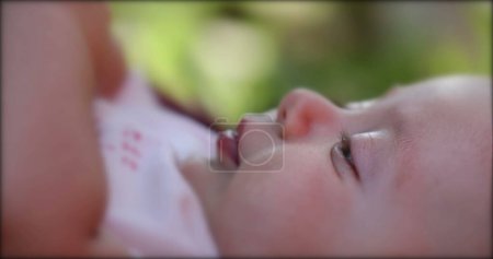 Photo for Newborn baby infant lying on grass outdoors in dreamy day - Royalty Free Image