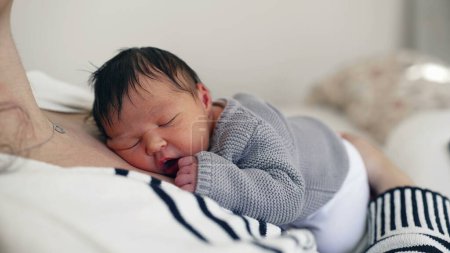Photo for Gentle Embrace - Newborn Rests on Mother's Chest, Surrounded by Love in the Early Days of Life - Royalty Free Image