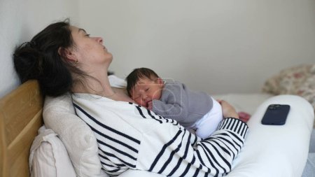 Tired Mother and Newborn Asleep Together During Afternoon Nap - Struggling with Fatigue in the First Week of Maternal Care