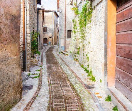 Photo for Alley with cobblestones between the ancient houses in the village of Petrella Salto in the province of Rieti. Italy. - Royalty Free Image