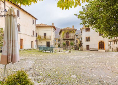 Photo for Stone fountain in the square of the ancient village of Colle di Tora located on the shores of Lake Turano in the province of Rieti. Italy. - Royalty Free Image