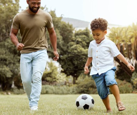 Photo for Man, boy and bonding with soccer ball in garden, house backyard or nature grass park for fun game, match and competition. Smile, happy and football for father and kid in fitness, exercise and workout. - Royalty Free Image