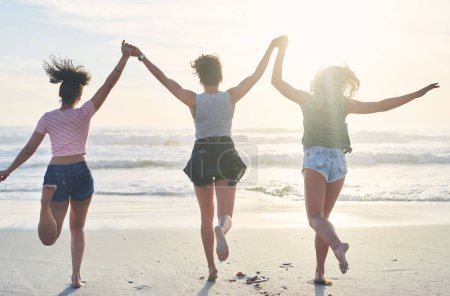 Photo for Go all out with the fun this summer. three friends spending the day at the beach - Royalty Free Image
