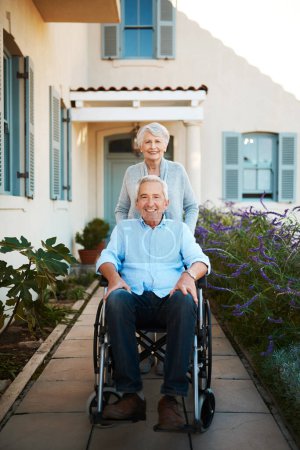 Photo for Shes always supported and stood behind me. Full length shot of a cheerful wheelchair bound senior man relaxing with his wife in their backyard at home - Royalty Free Image
