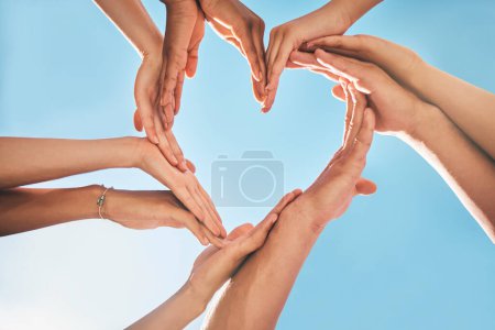 Heart, love and group hands for support, care and community with outdoor summer sunshine, blue sky and mock up. Group of people with care sign for solidarity, health and wellness background mockup.