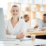 Portrait, business woman and computer in office or corporate workplace working with a smile. Happy worker, company employee or manager and leader at desk with career motivation, vision and mission