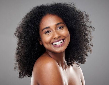 Photo for Black woman, makeup and beauty with hair, cosmetic and smile with afro, face and happiness. Model, happy and skincare with cosmetics, shine or glow on skin for hair care, wellness or health in studio. - Royalty Free Image