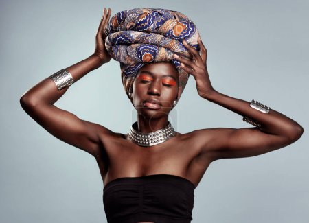 Photo for When you know who you are, nothing can stop you. Studio shot of a beautiful young woman wearing a traditional African head wrap against a grey background - Royalty Free Image