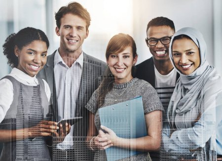 Photo for You have found the best team around. Portrait of confident young business people standing inside of the office at work during the day - Royalty Free Image