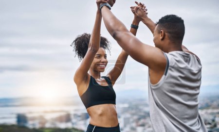 Photo for I feel as amazing as you do. a sporty young couple high fiving each other while exercising outdoors - Royalty Free Image
