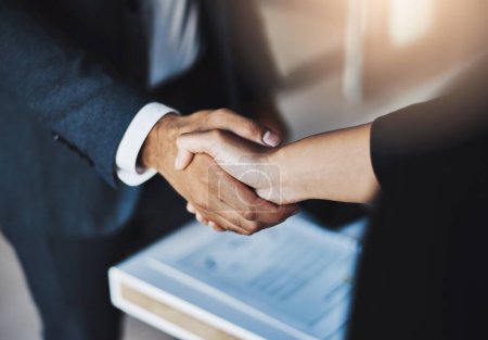 Mergers can help your business deliver increased market power. Closeup shot of two unrecognizable businesspeople shaking hands in an office Poster 619719398