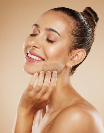 Photo for Natural, health and beauty woman with skincare feeling soft and beautiful face glow with hand. Healthy, body care and smile of girl satisfied with skin in beige studio for cosmetic marketing - Royalty Free Image